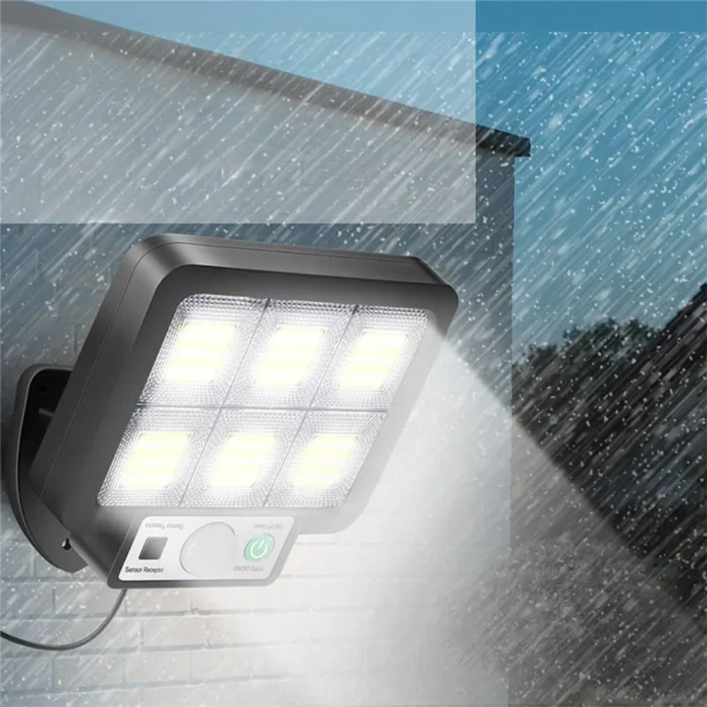 Solar wall light fixture on a rainy day with water droplets.