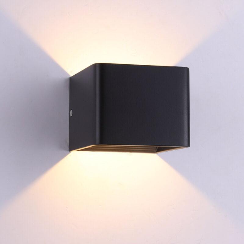 Black square wall light fixture on a white wall