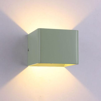 Green wall-mounted light fixture on a gray background