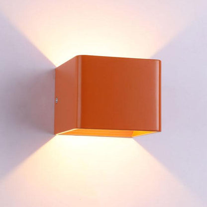 Orange square wall light fixture on a white wall
