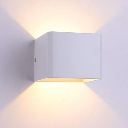 White wall-mounted LED light fixture on a white wall