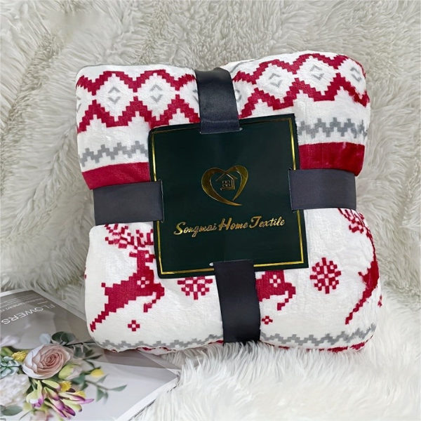 Folded blanket with red and white pattern and black ribbon, branded 'Sunbeam Home Textiles', on a textured surface.