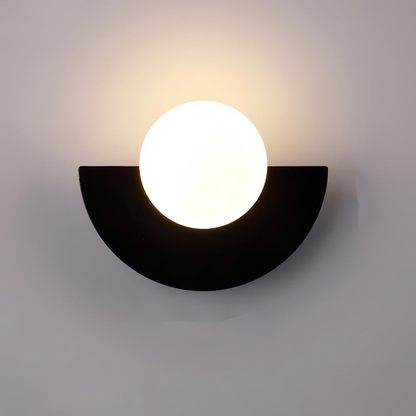Wall-mounted light fixture with a black semi-circular base and white circular light bulb on a gray background
