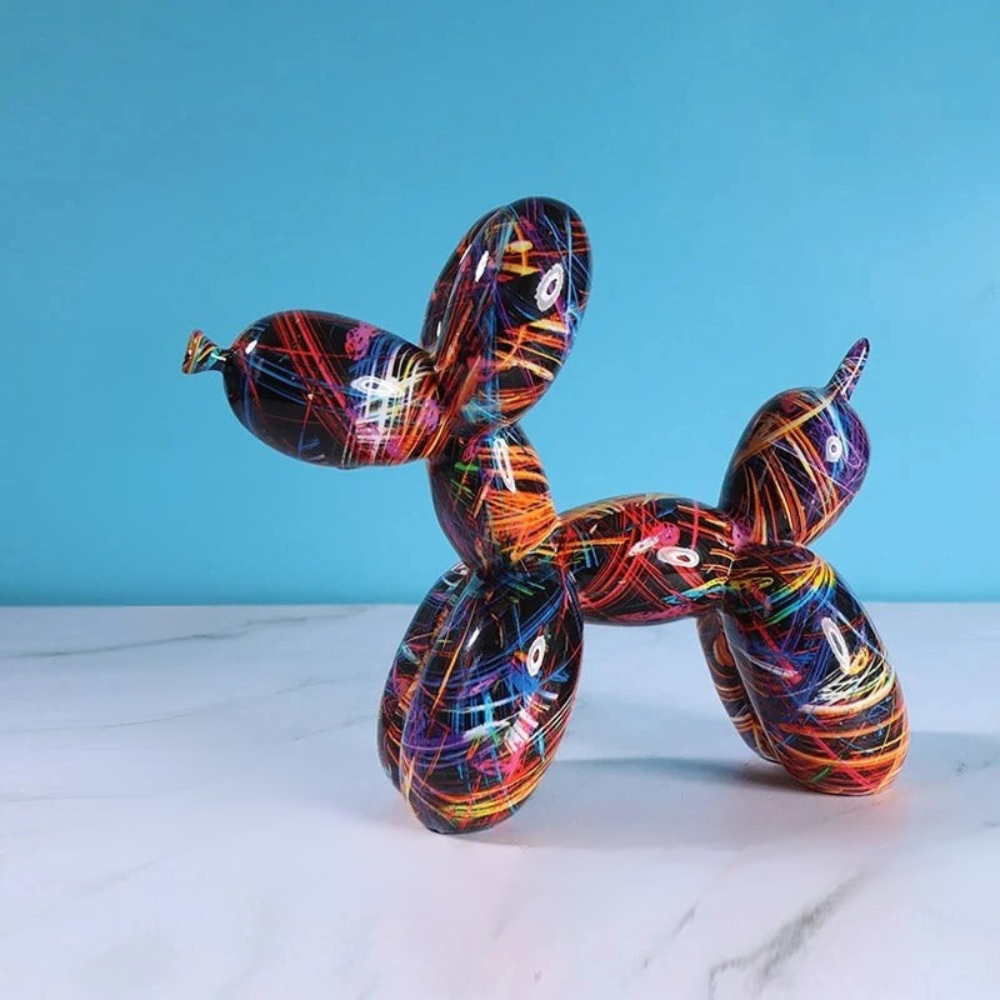 Colorful balloon dog sculpture on a marble surface with a blue background