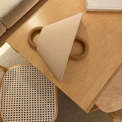 Wooden surface with a geometric object and woven mat