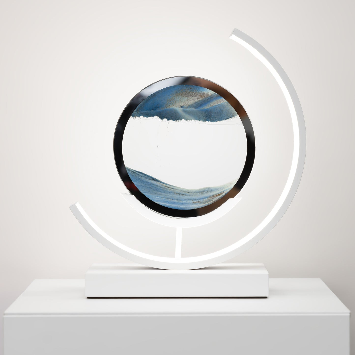 Decorative object with circular design and LED light on a white surface