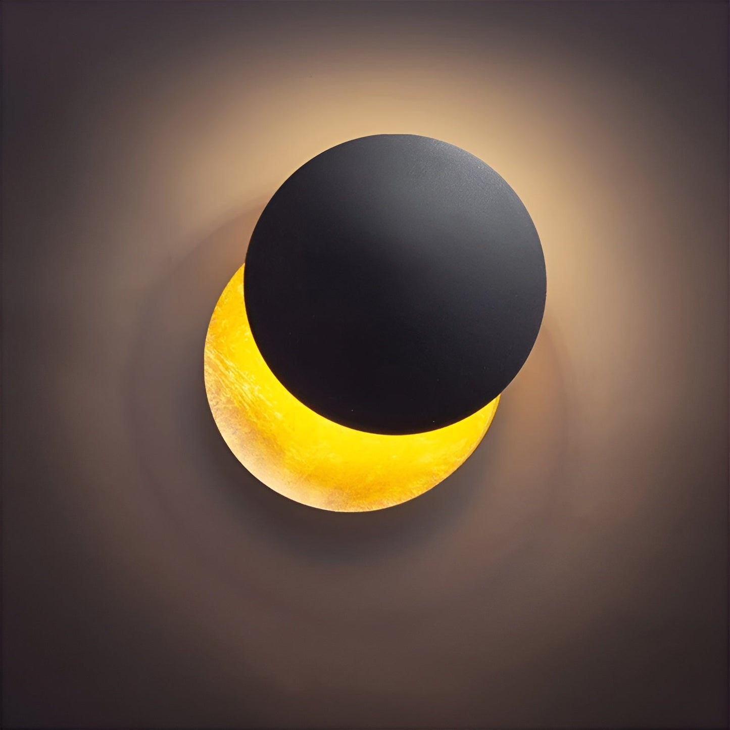Wall-mounted lamp with black top and yellow bottom on a dark background