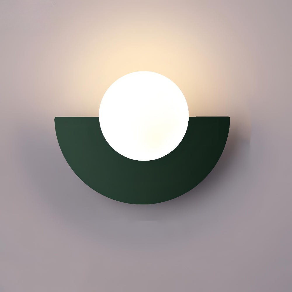 Wall-mounted light fixture with a green semi-circular base and white circular light on a gray background