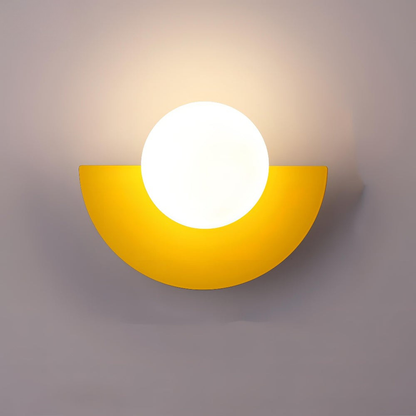 Yellow wall sconce with a white light bulb on a gray background