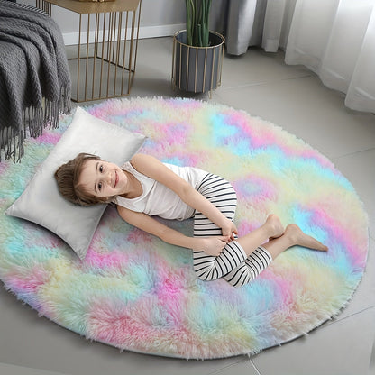 Child lying on a colorful round rug in a room with a plant and table.