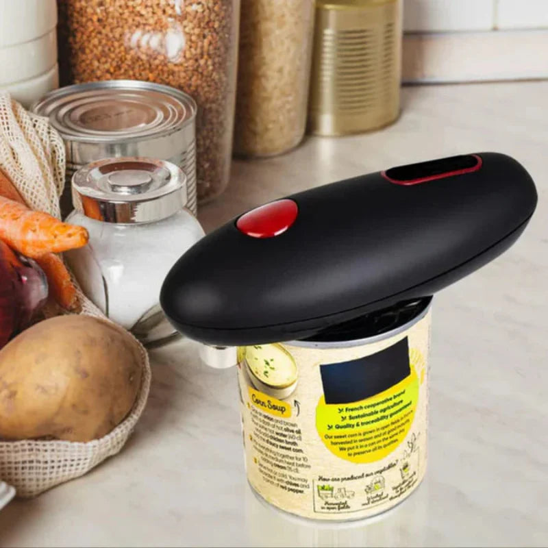 Can opener on a can with kitchen items in the background