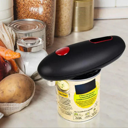 Can opener on a can with kitchen items in the background