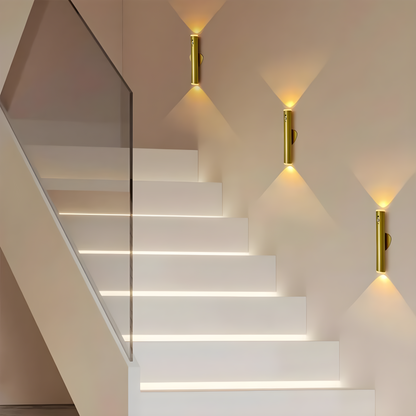 Modern staircase with wall-mounted lights in a minimalistic setting