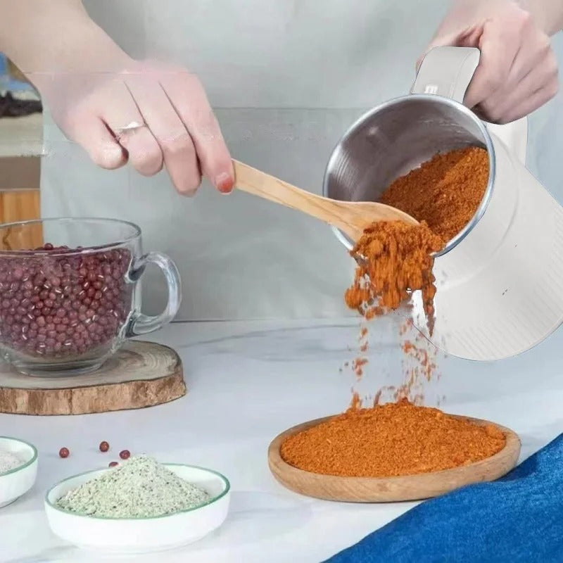 Person pouring orange powder from a measuring cup into a wooden bowl on a kitchen counter.