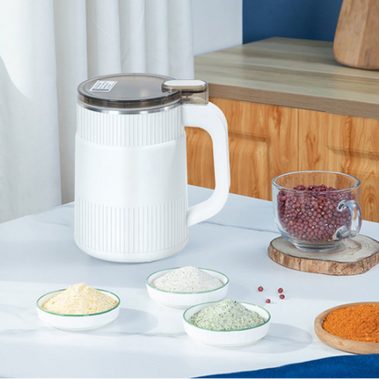 White kitchen appliance on a table with various ingredients around it.