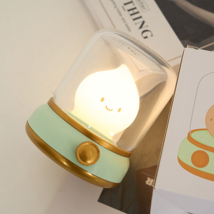 Small night light with a smiley face on a surface next to a box