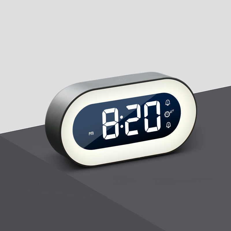 Digital clock with LED display on a gray surface