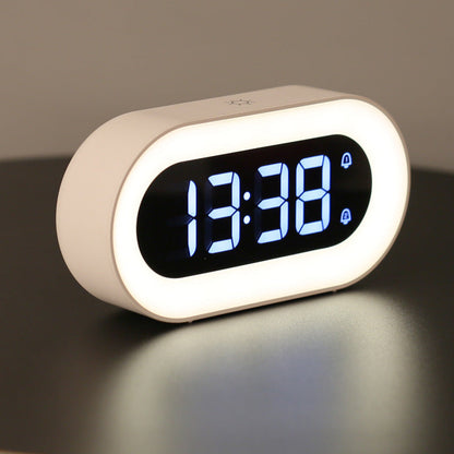Digital clock with white casing and blue LED display on a dark background
