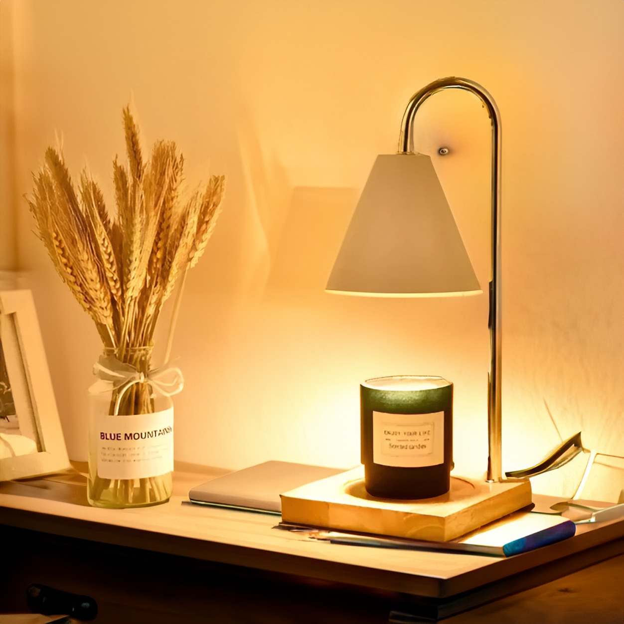 Lamp, candle, and jar on a wooden surface with a warm glow