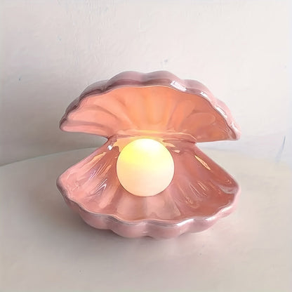 Pink shell-shaped container with a light inside on a white background
