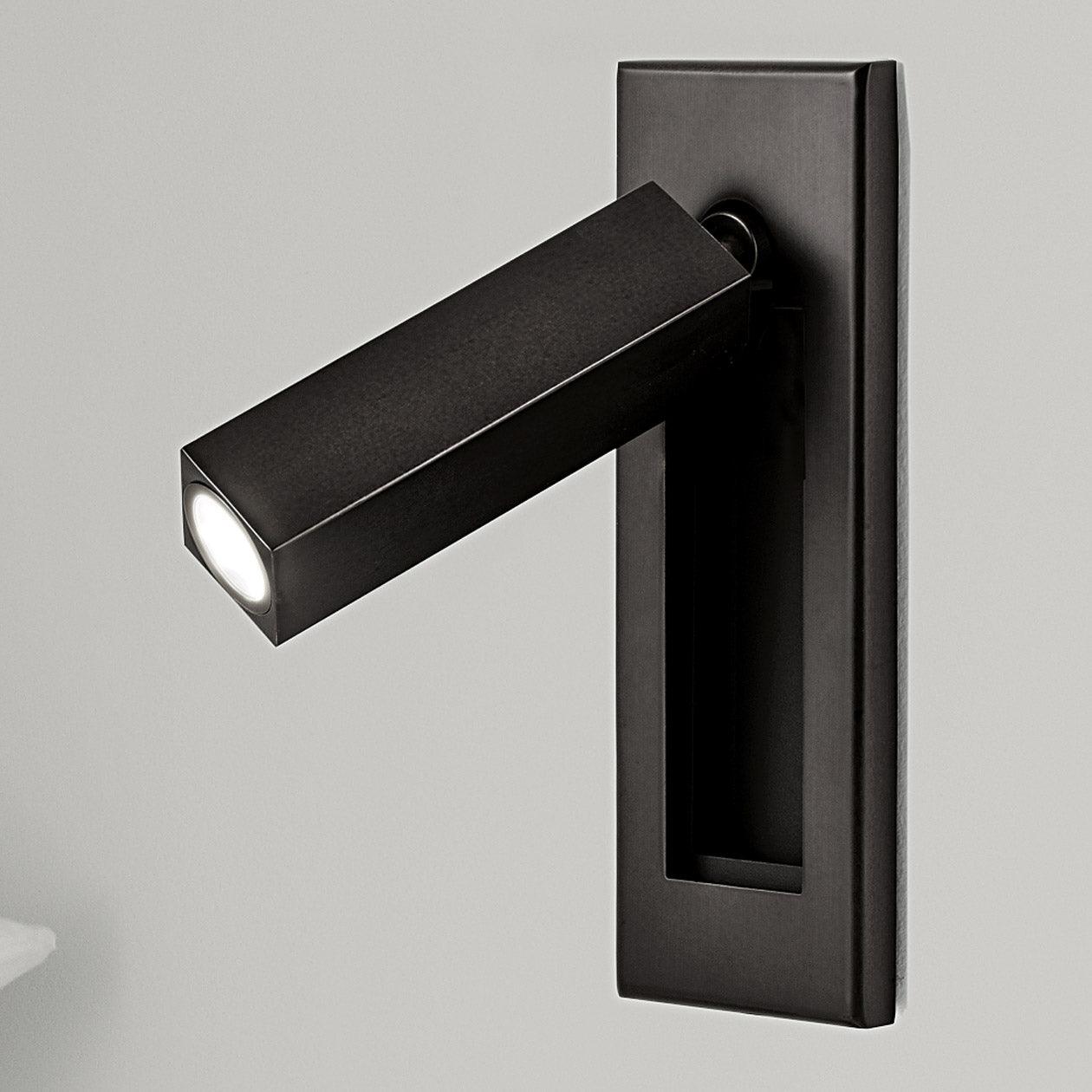 Black wall-mounted light fixture on a gray background