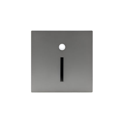 Square metallic object with a central cylindrical element on a white background