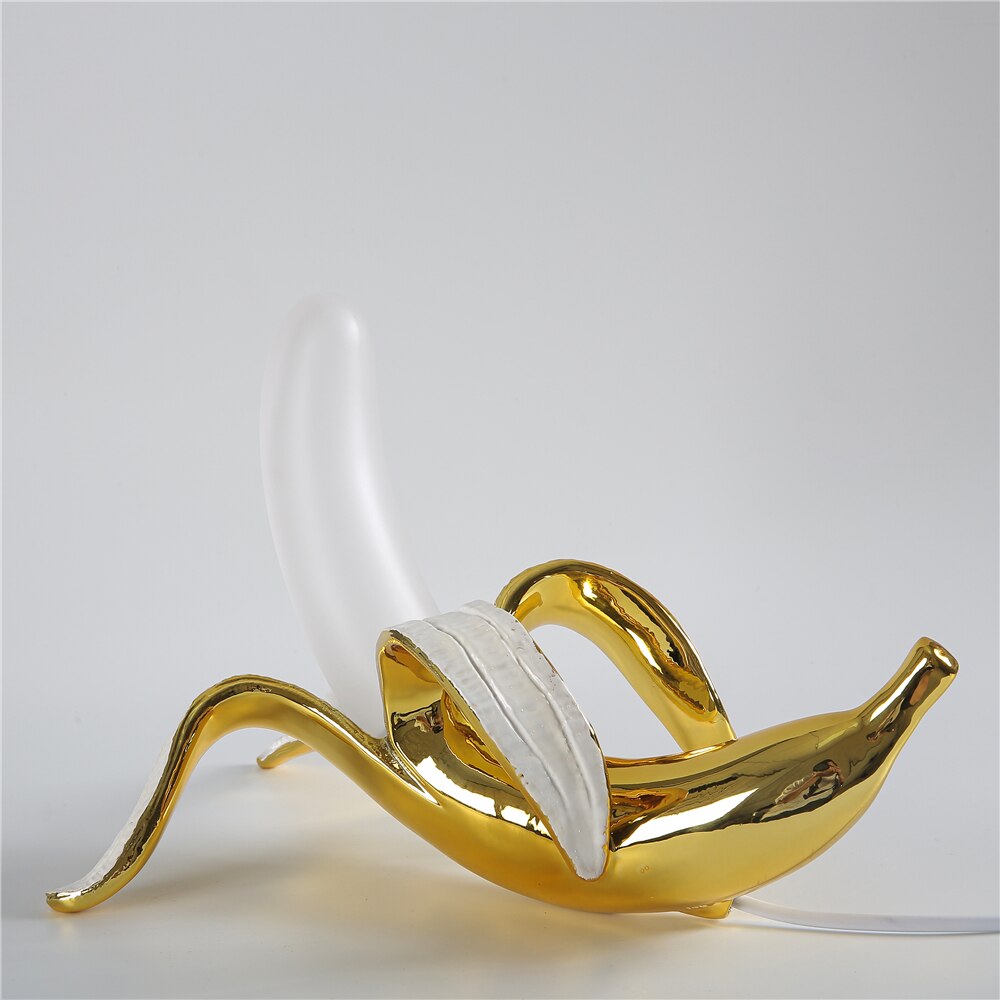 Gold and white decorative item on a light gray background