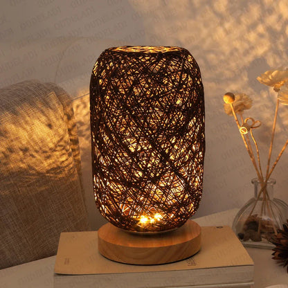 Woven rattan table lamp on a surface with a warm glow