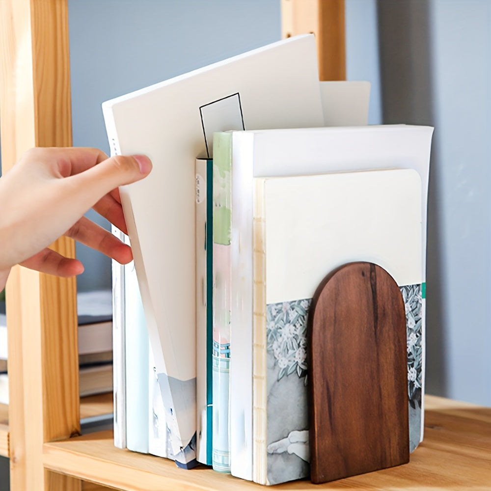 Hand opening a book with a wooden cover on a shelf