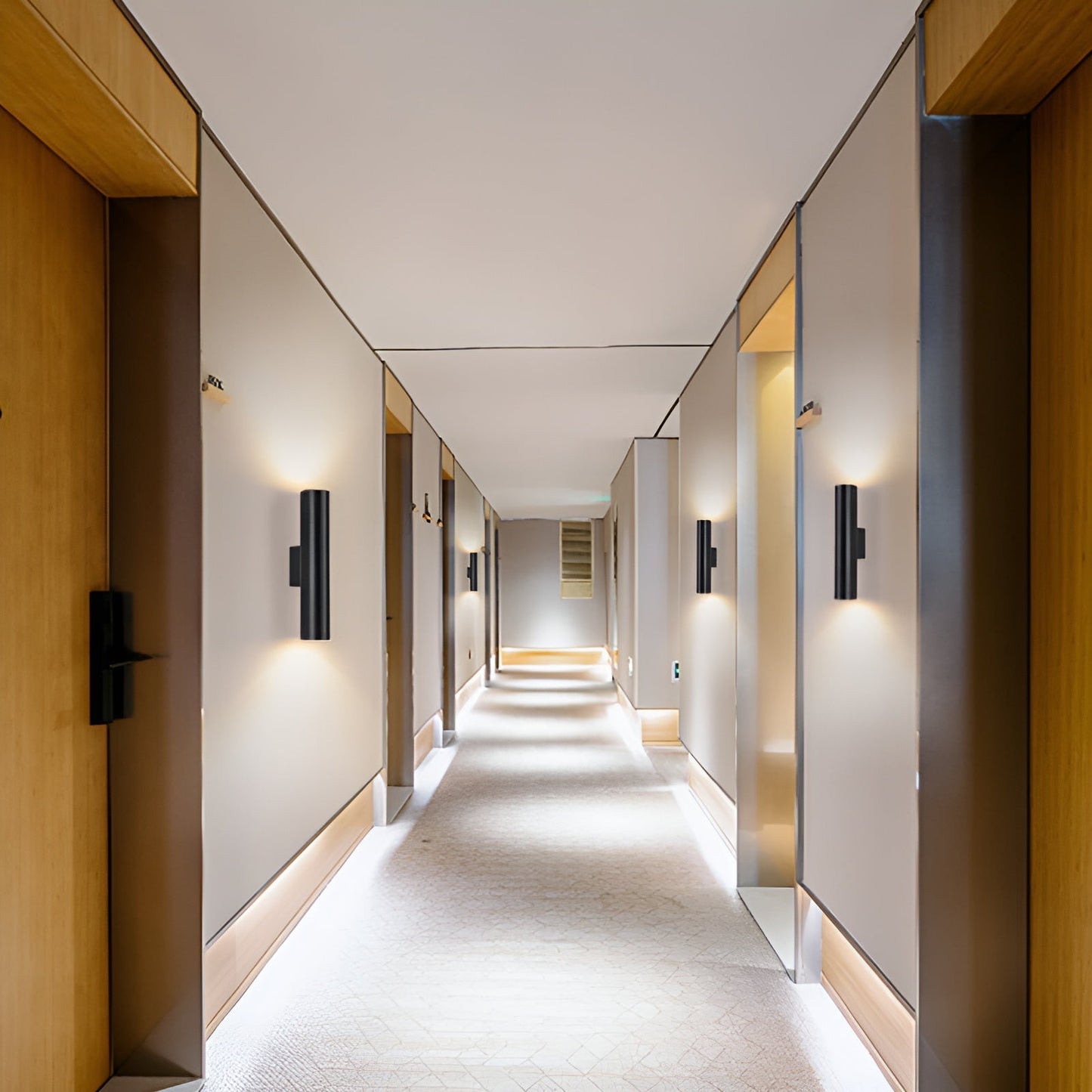 Modern hallway with light fixtures and doors on either side