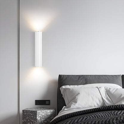 Modern wall-mounted light fixture in a bedroom setting.