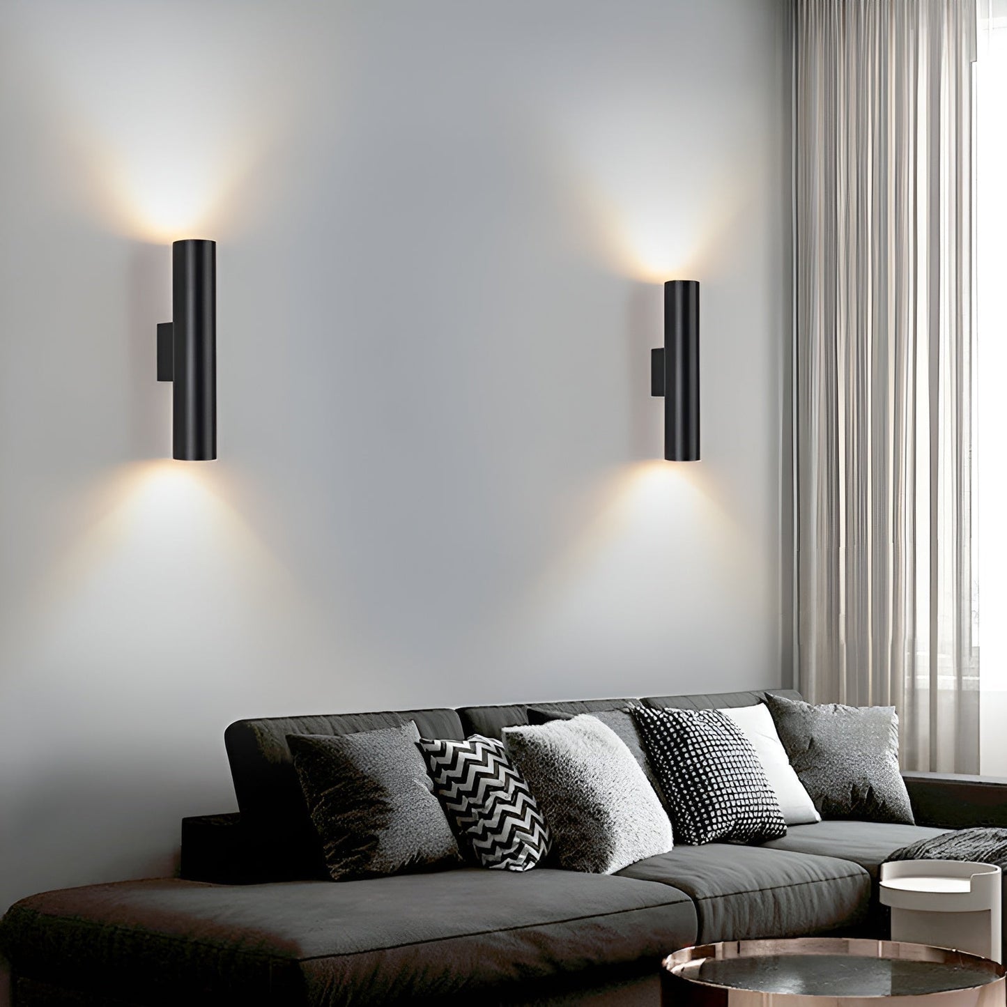 Modern living room with a gray sectional sofa and wall-mounted lights.