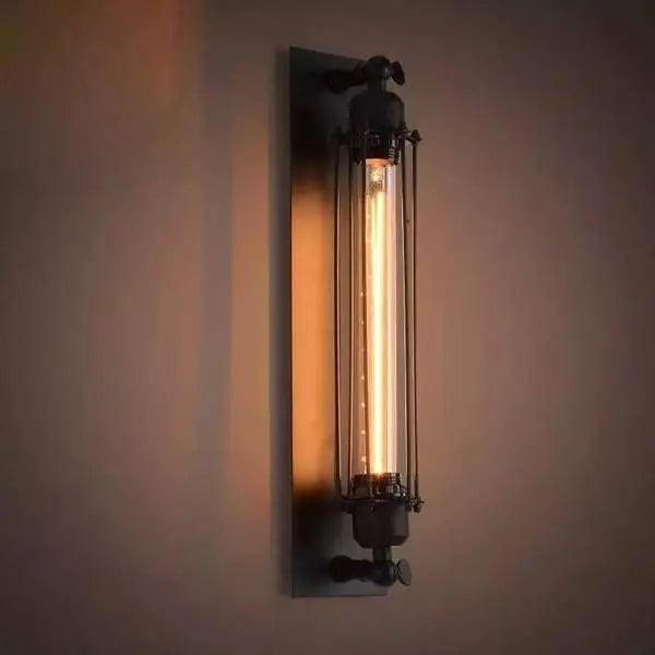 Vintage-style wall lamp with a warm glow on a plain wall.