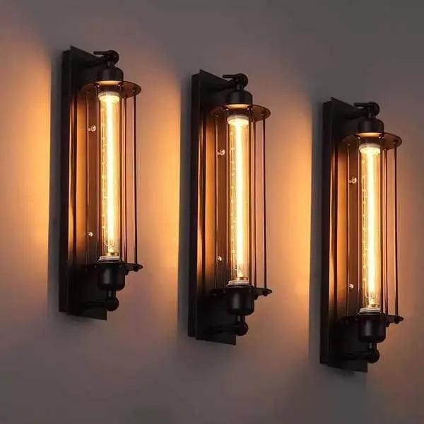 Three wall-mounted lights with glass shades on a gray background