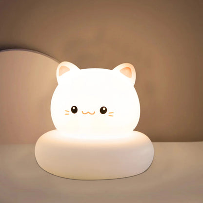 Cute cat-shaped night light on a plain background