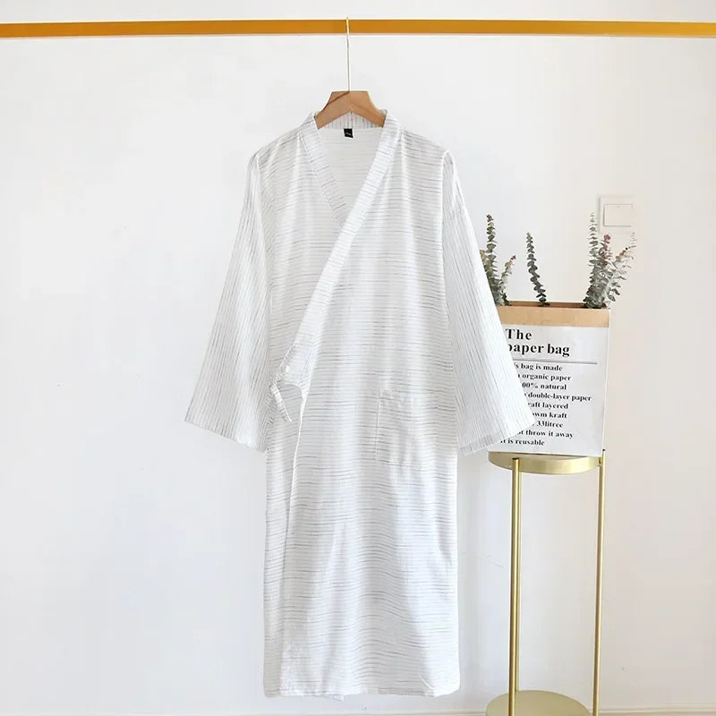 White striped shirt on a hanger with a white paper bag in the background