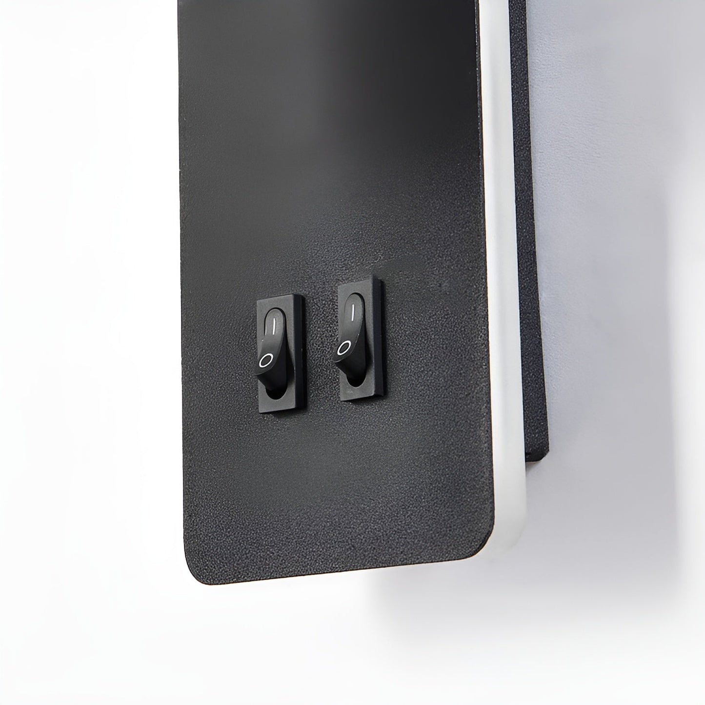 Black control panel with two switches on a white background