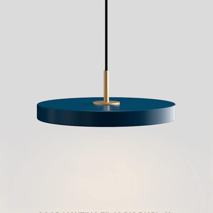 Blue pendant light with gold fixture on a gray background