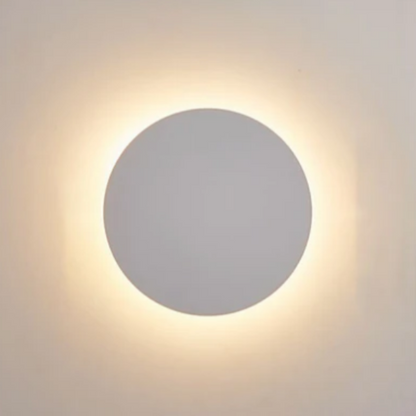 Round wall light fixture on a plain wall