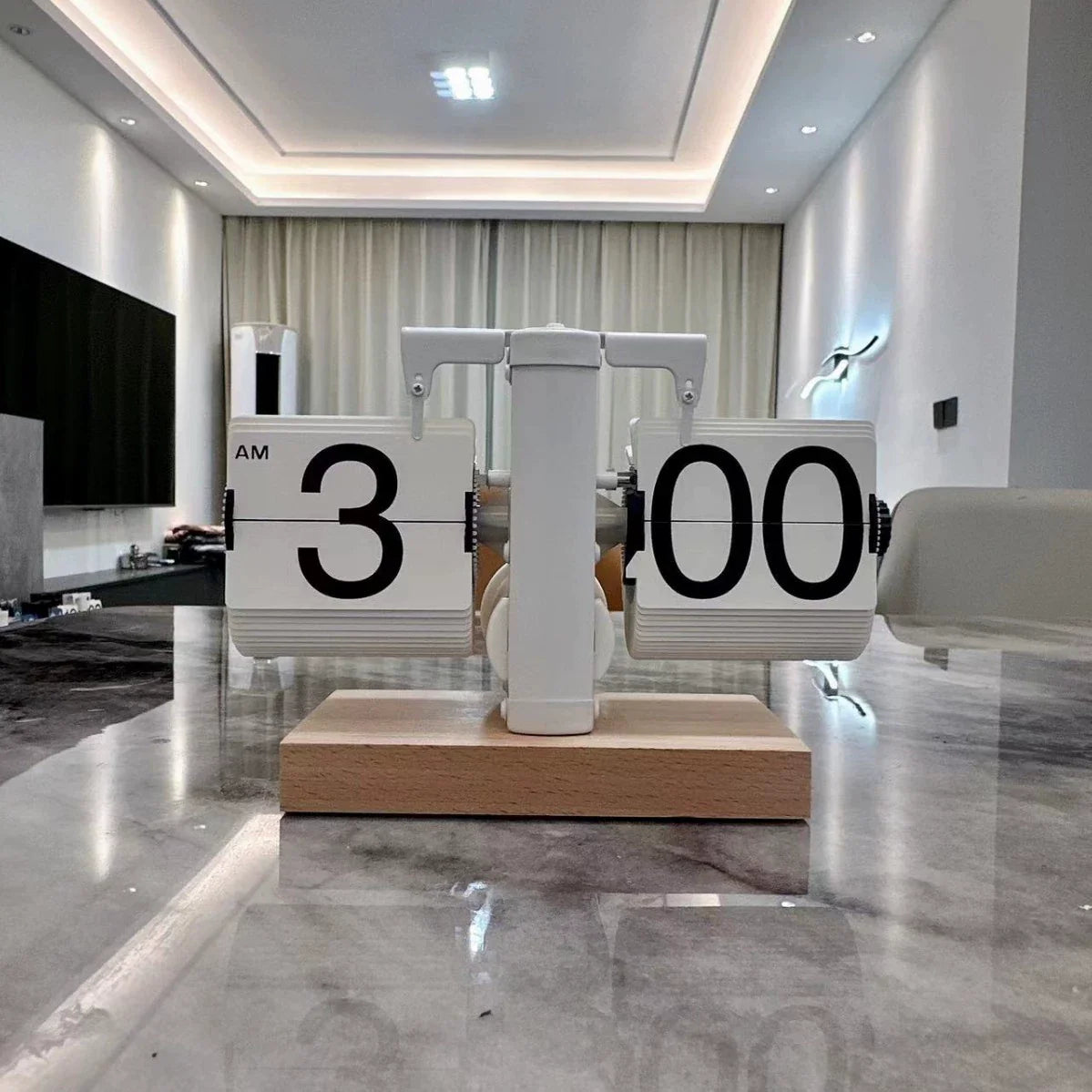Modern kitchen with a unique clock design on a marble floor.