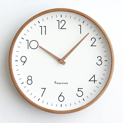Wall clock with wooden frame and white face on a light background