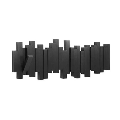 Modern wall clock with black geometric design on a white background