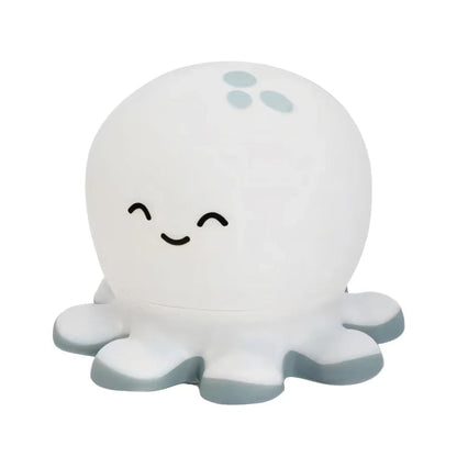 White octopus-shaped night light with a smiling face on a white background