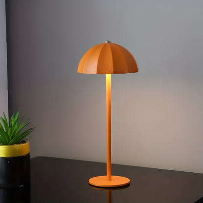 Orange table lamp on a dark surface with a gray background