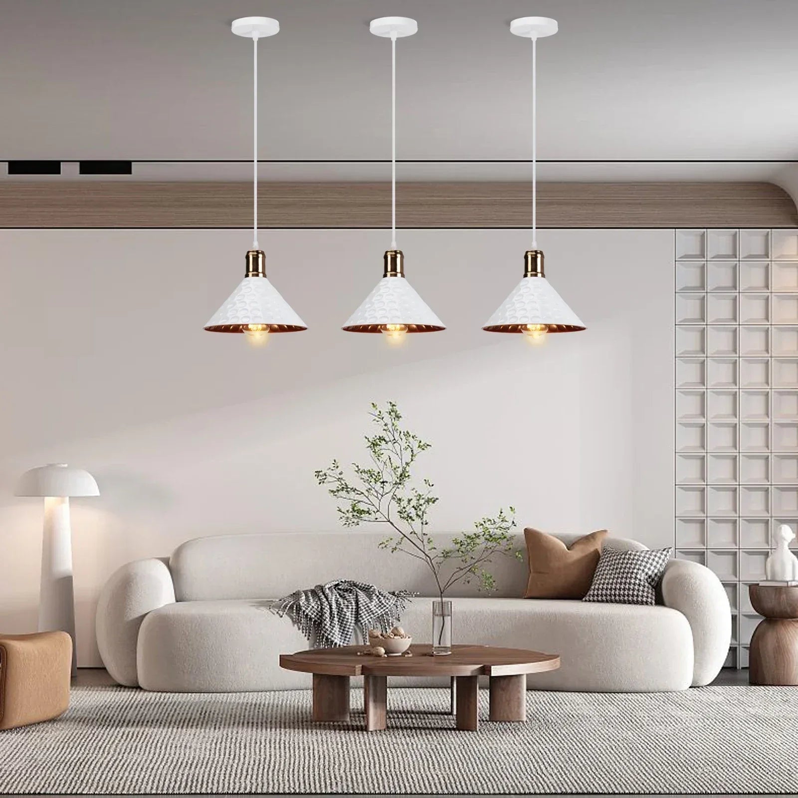 Modern living room with a white sofa, wooden coffee table, and pendant lights.