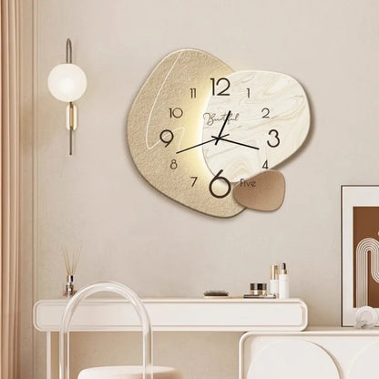 Decorative wall clock on a wall with a lamp and table in the background