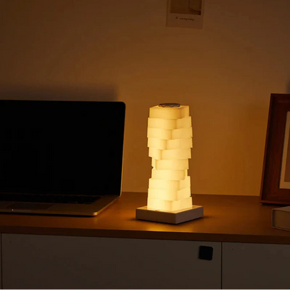 Lamp on a desk with a laptop and decorative items