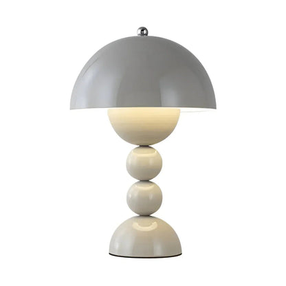 Modern table lamp with a gray dome shade and white cylindrical base on a white background