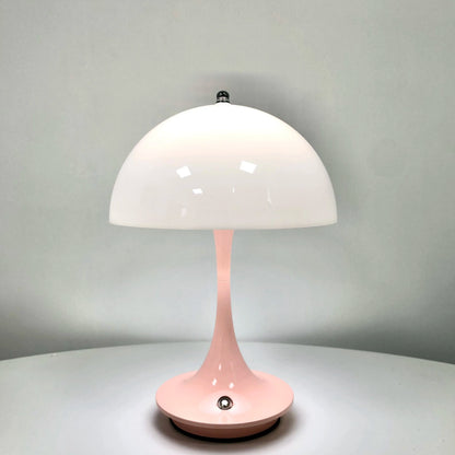Pink table lamp with a white shade on a gray background