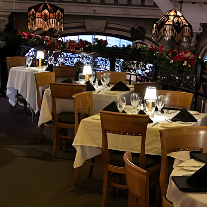 Dining area with tables set for meals, chairs, and decorative elements in a restaurant.